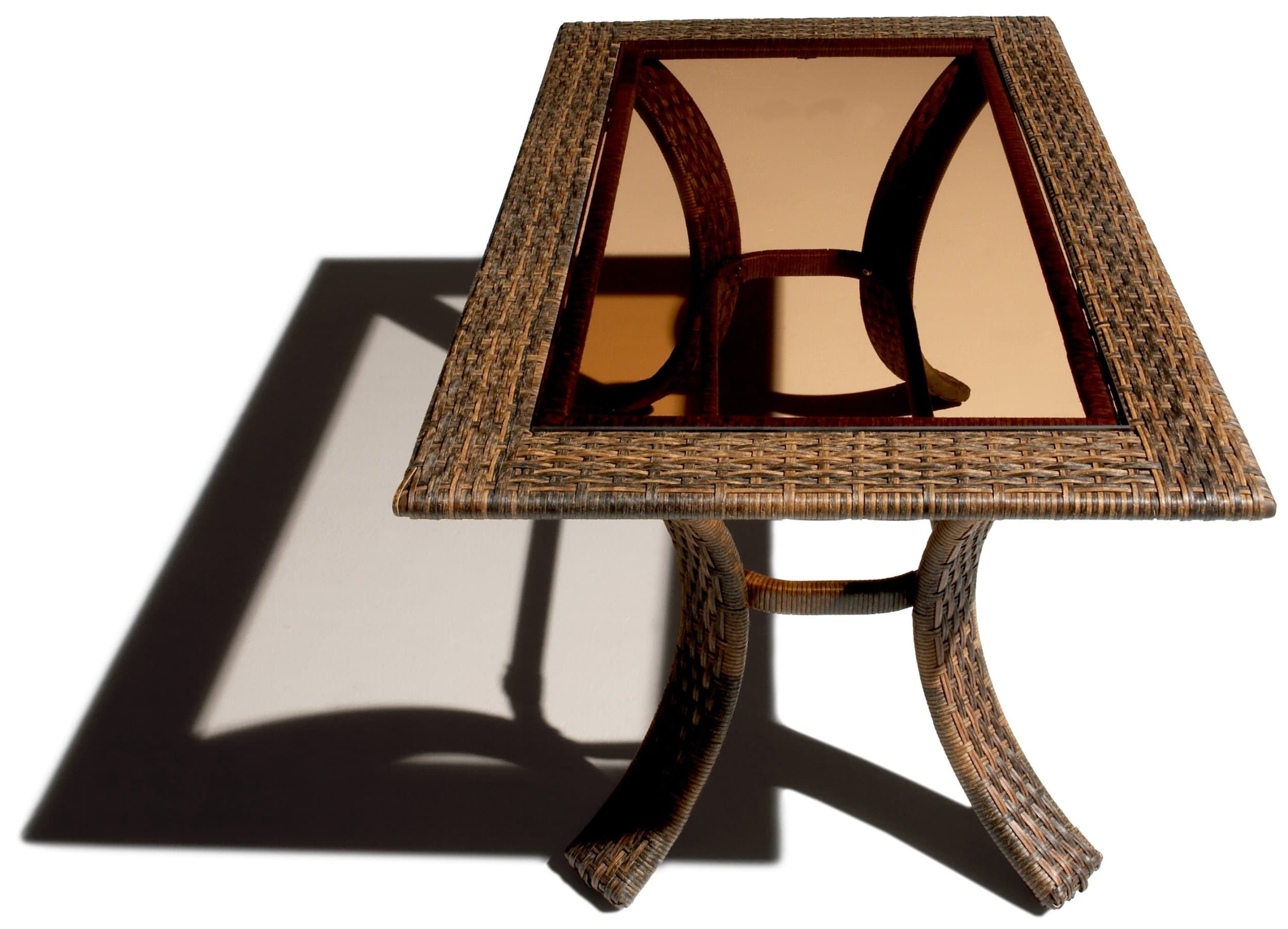 End view of the Strathwood wicker coffee table, showing the glass tabletop and curved supports.