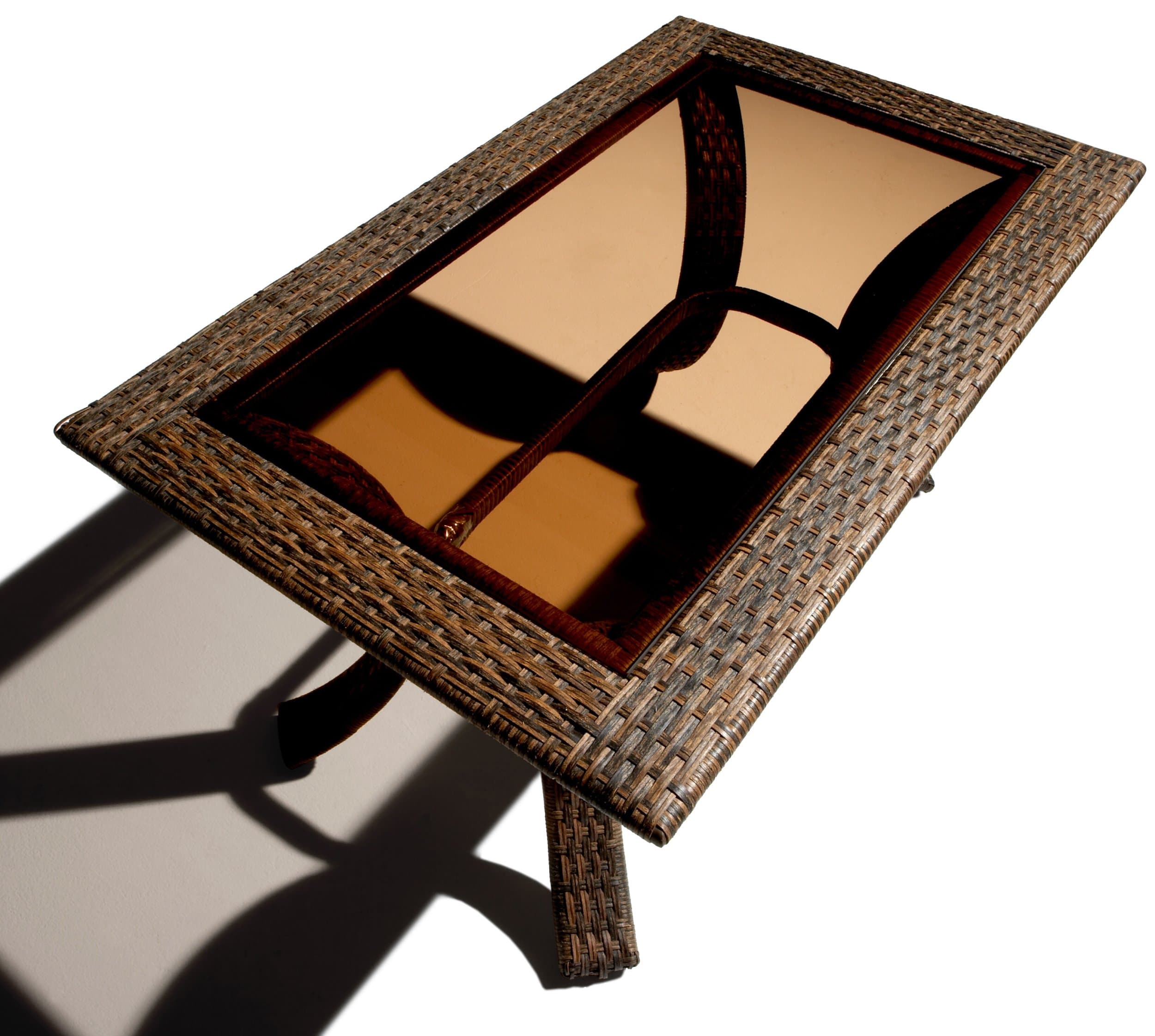 Elevated three-quarter view of the Strathwood wicker coffee table, showing the glass inset and woven frame.