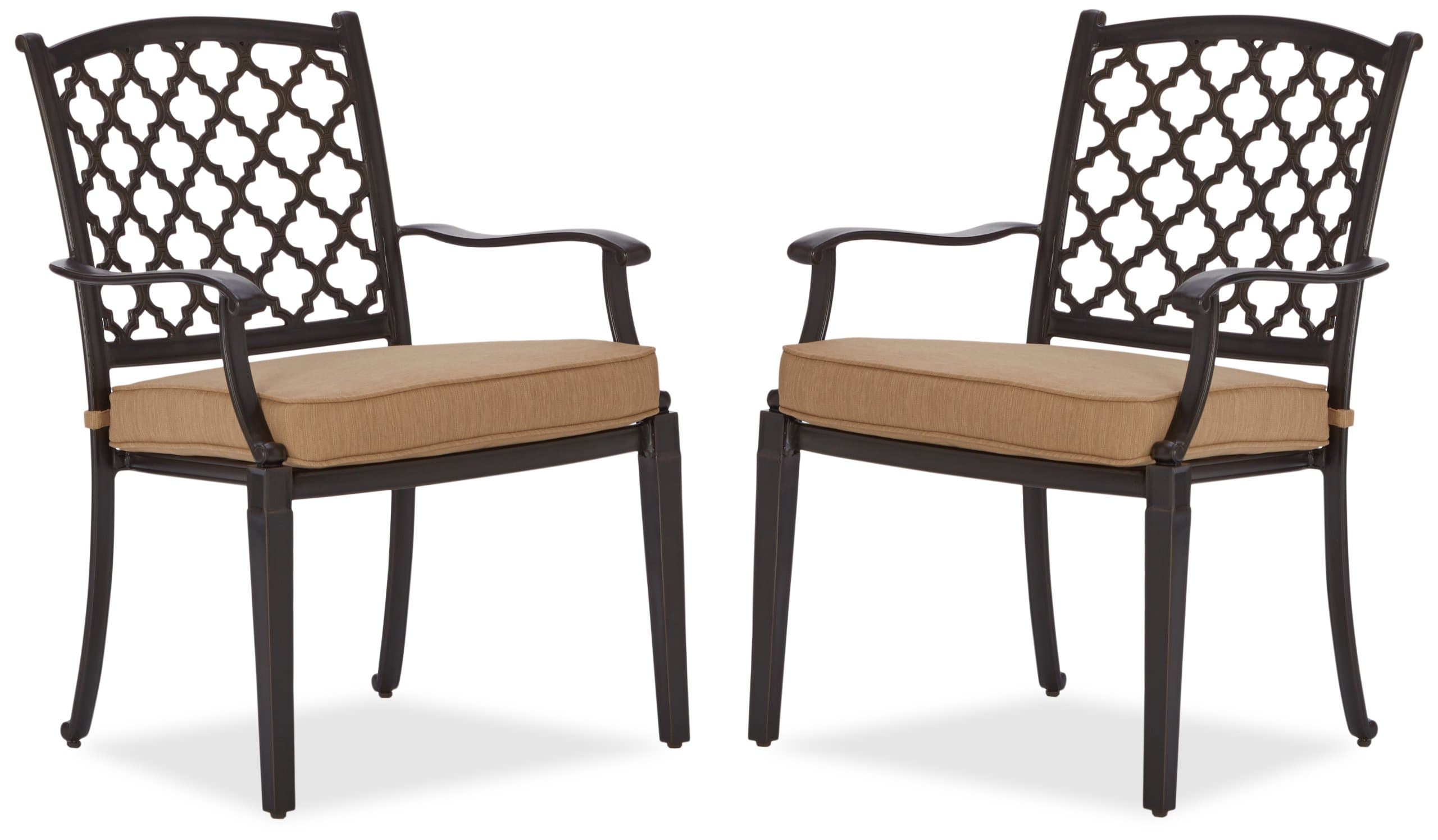 Two Strathwood Whidbey cast-aluminum dining arm chairs with tan seat cushions and dark lattice backs.