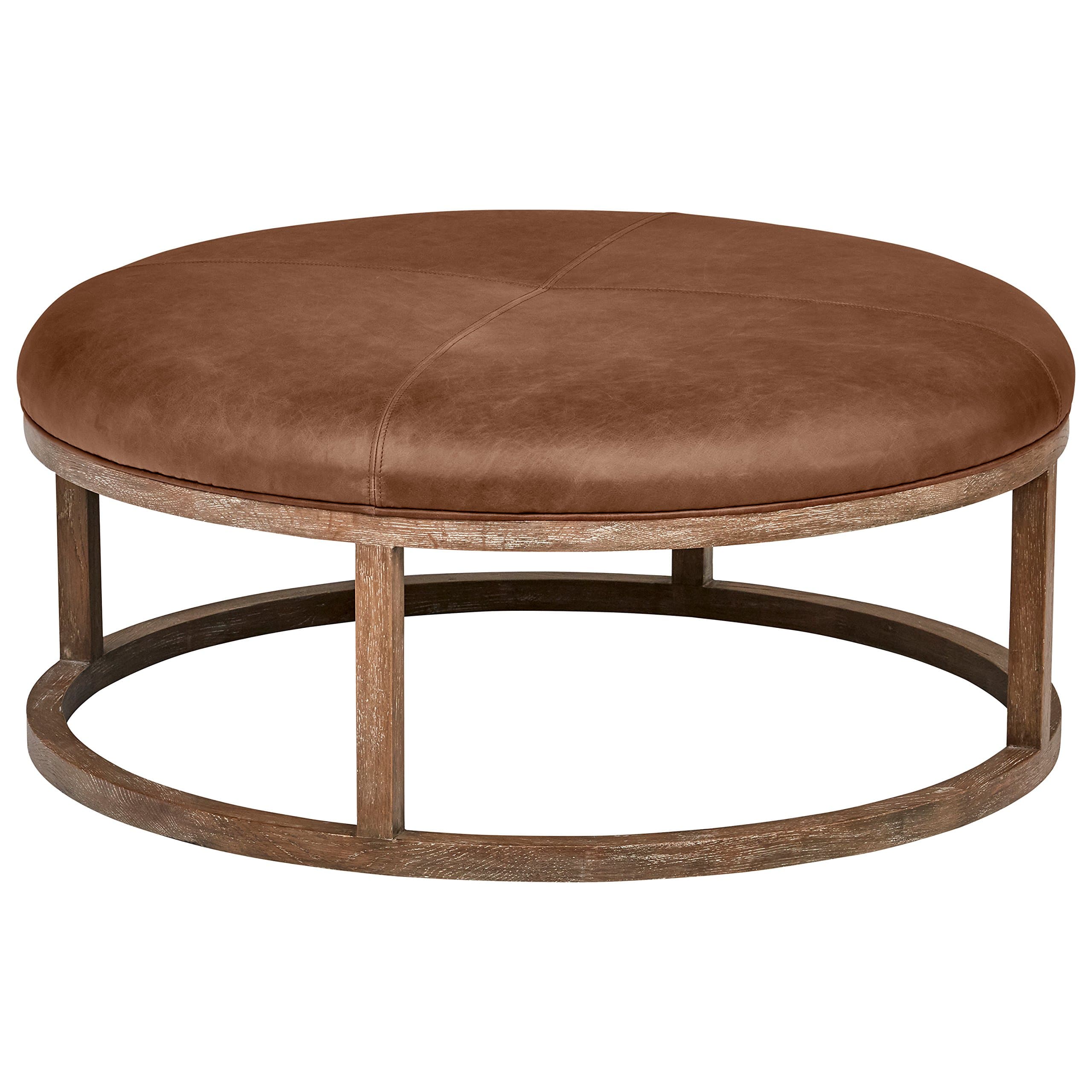 Stone & Beam Norah saddle-brown leather ottoman with circular wood frame.
