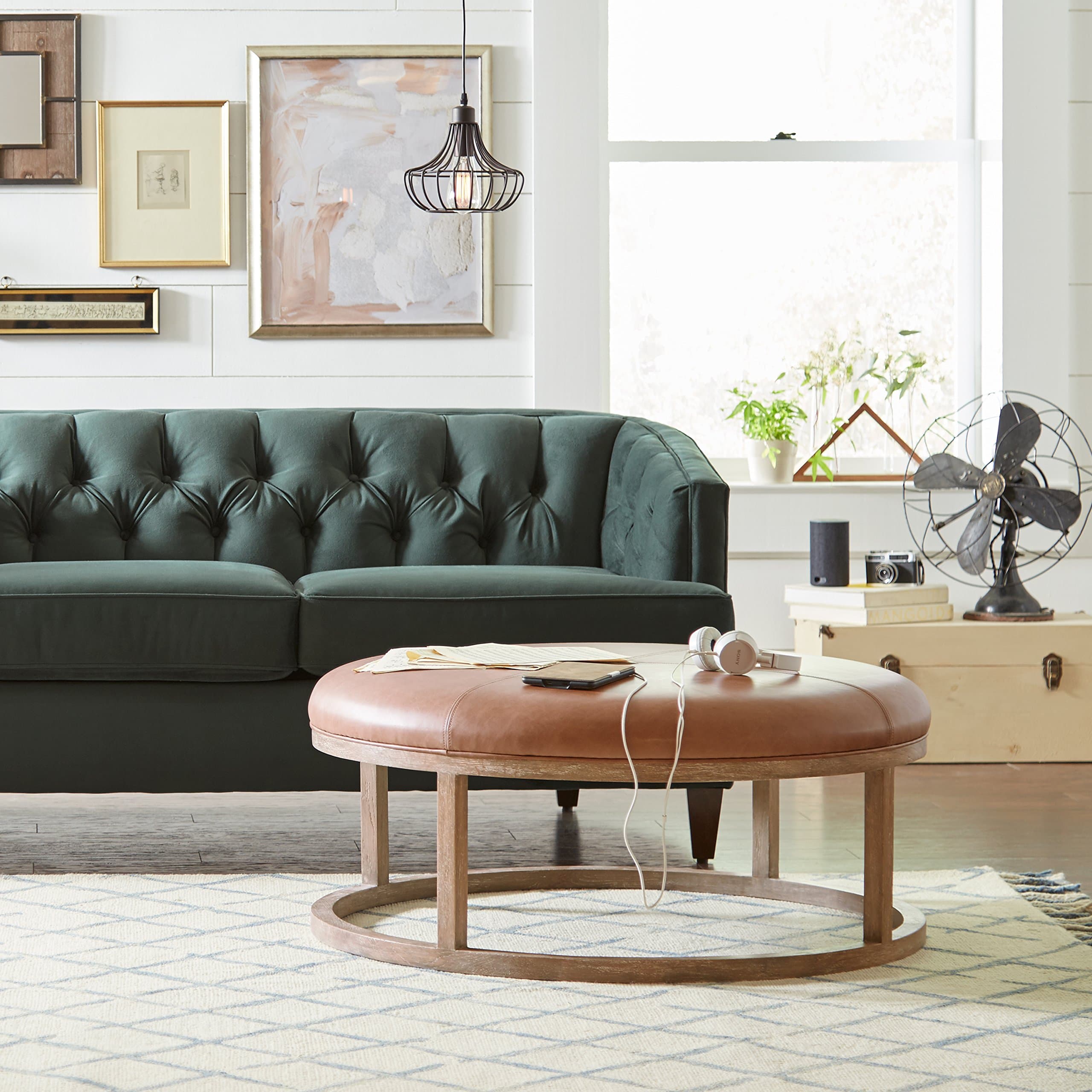 Stone & Beam Norah ottoman in front of a sofa in a living room.