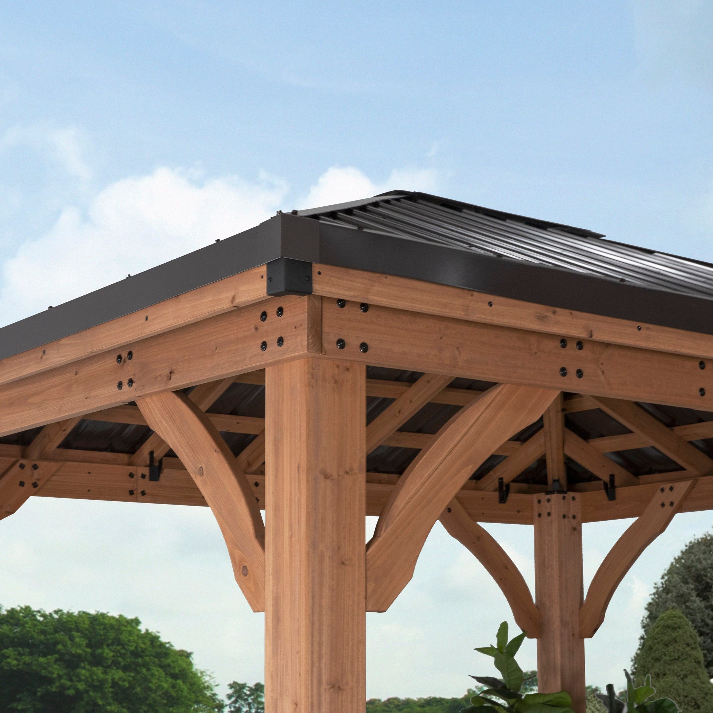 Exterior corner showing the hip roof edge and cedar post