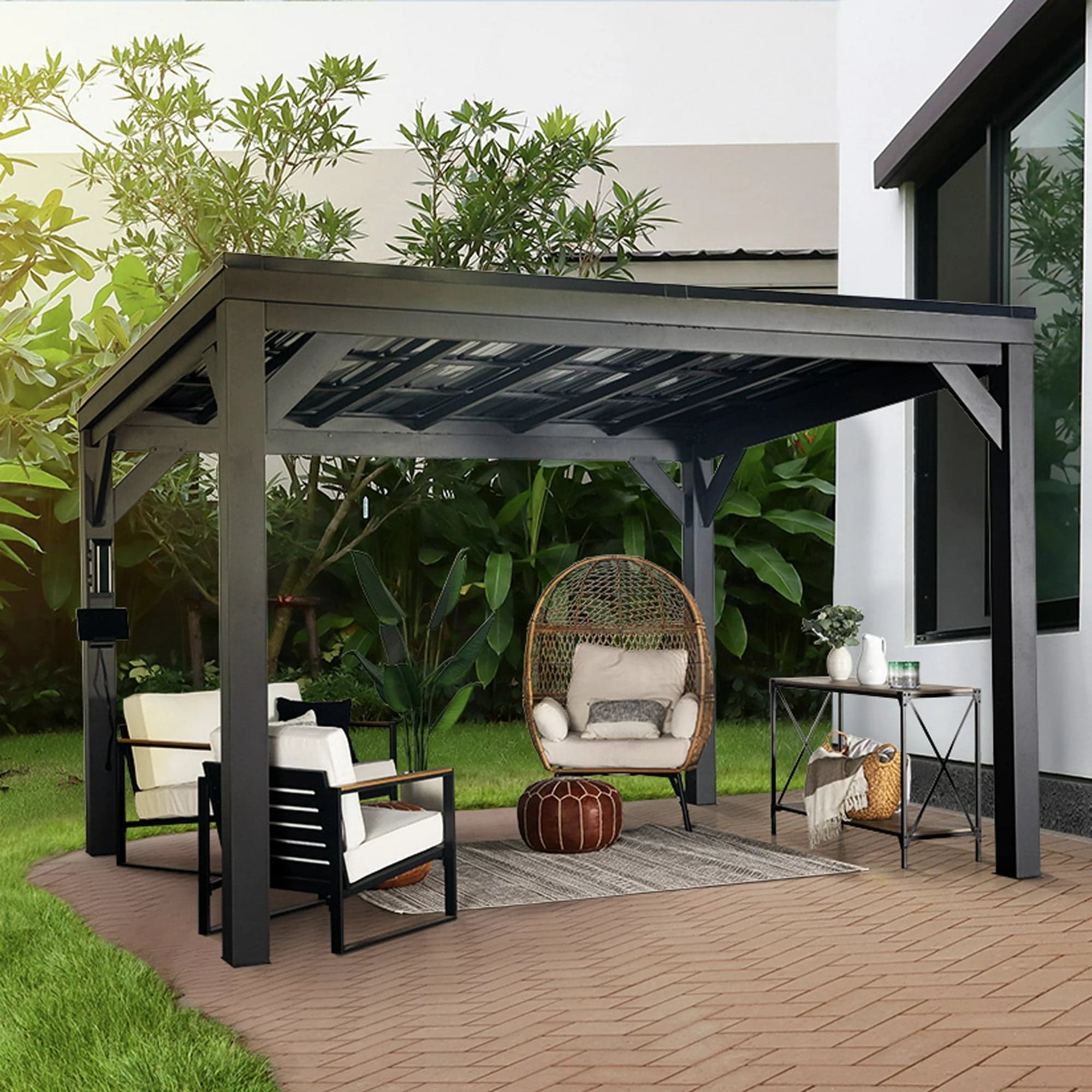 Three-quarter view of the black steel Stonebridge gazebo with patio seating