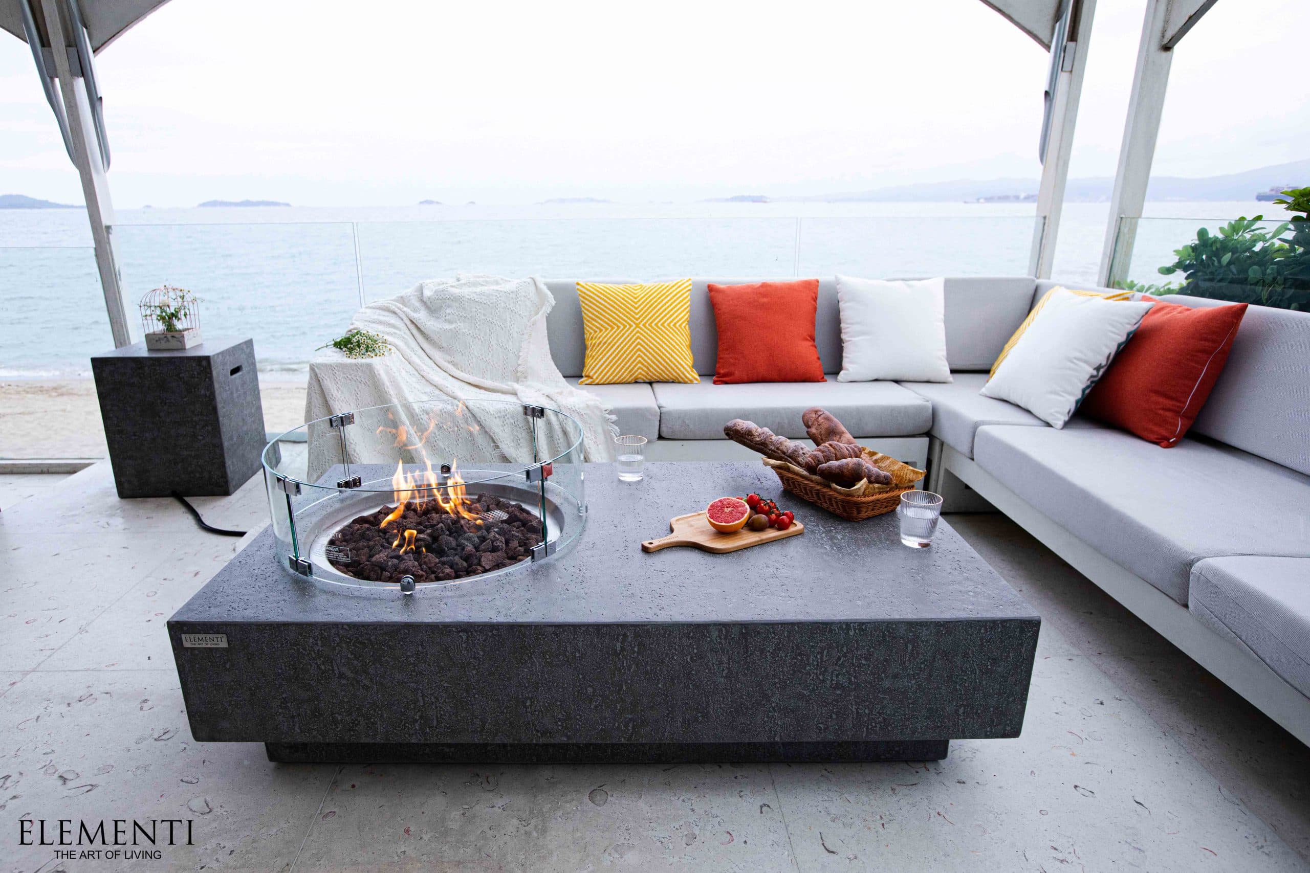 Metropolis table on a seaside patio with optional wind guard