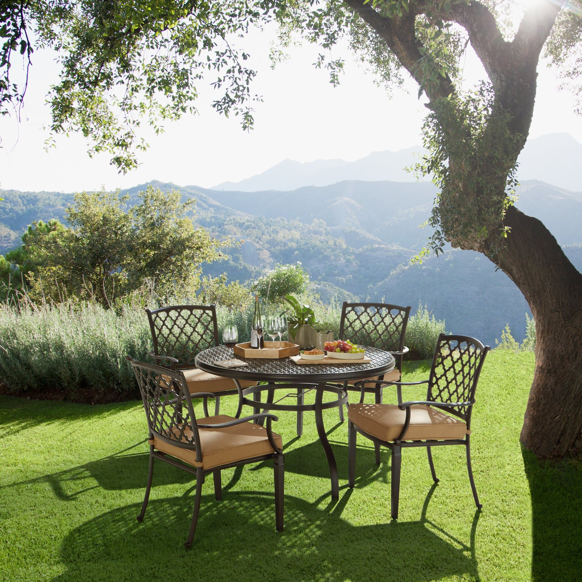 Strathwood Whidbey Cast-Aluminum Round Dining Table — table in an outdoor dining arrangement; chairs sold separately.